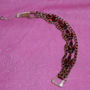 Alternative view of Mid Century Red Rhinestone triple strand on gold bracelet